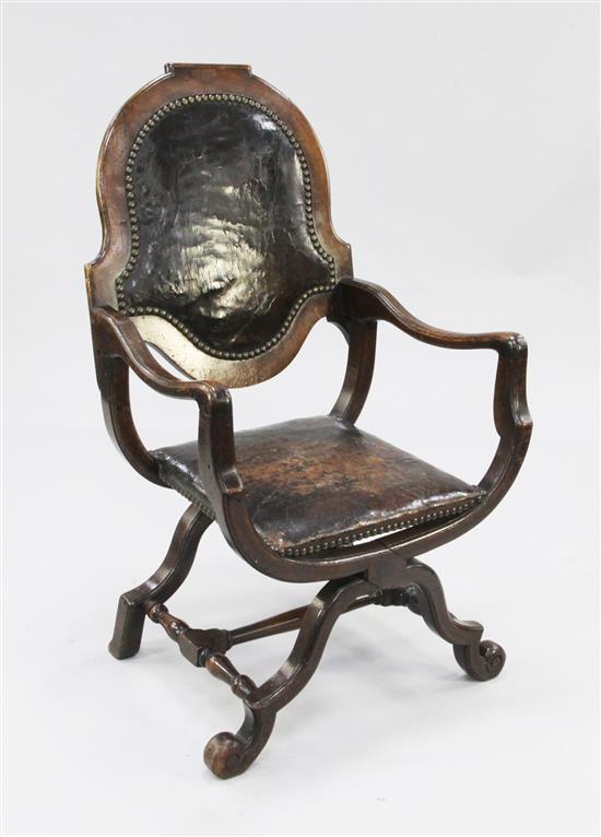 A 19th century Spanish style walnut and studded leather X frame open armchair